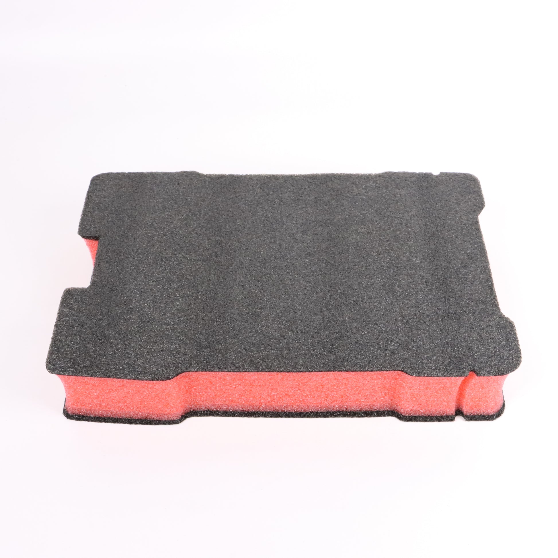 Side view of a black and red layered EPE foam blank for a compact tool case